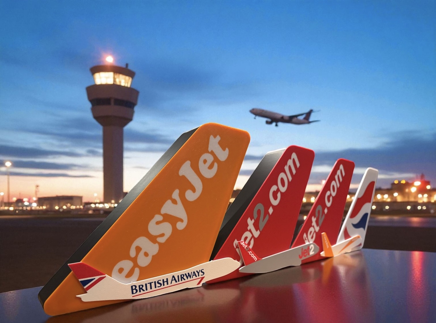 LED lit airline tail fin replicas displayed with airport control tower at dusk