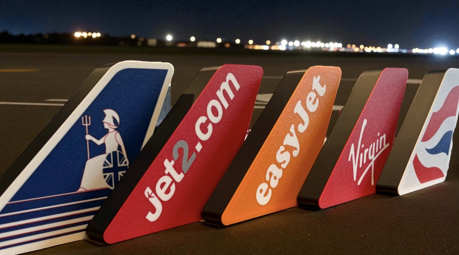 LED tail fins displayed on airport tarmac at night